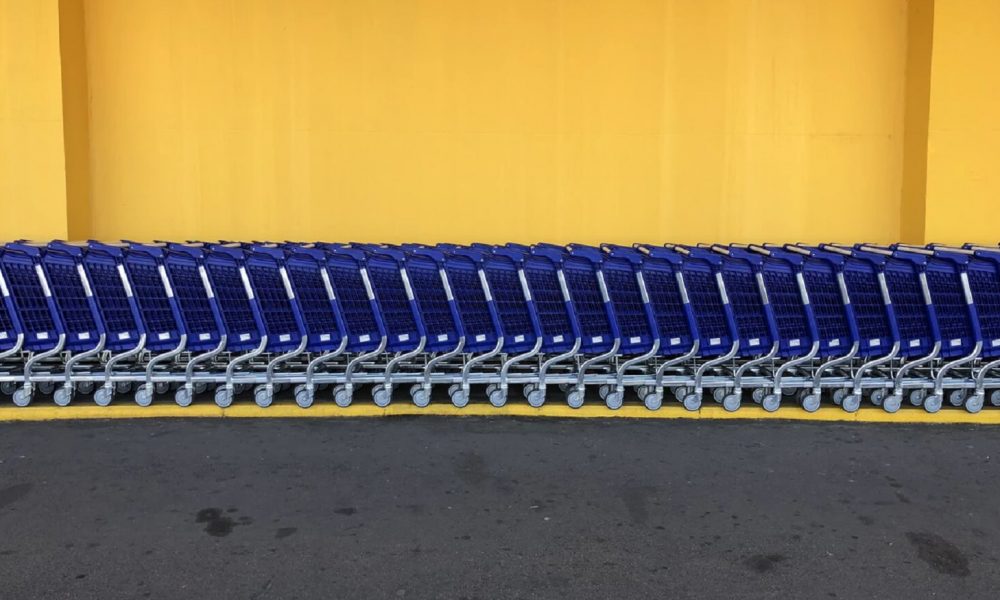 walmart shopping carts against yellow wall